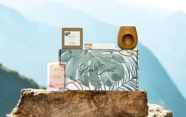 Gel Wax P1 A luxurious wax melt gift set displayed on a rock with a stunning mountain view in the background.