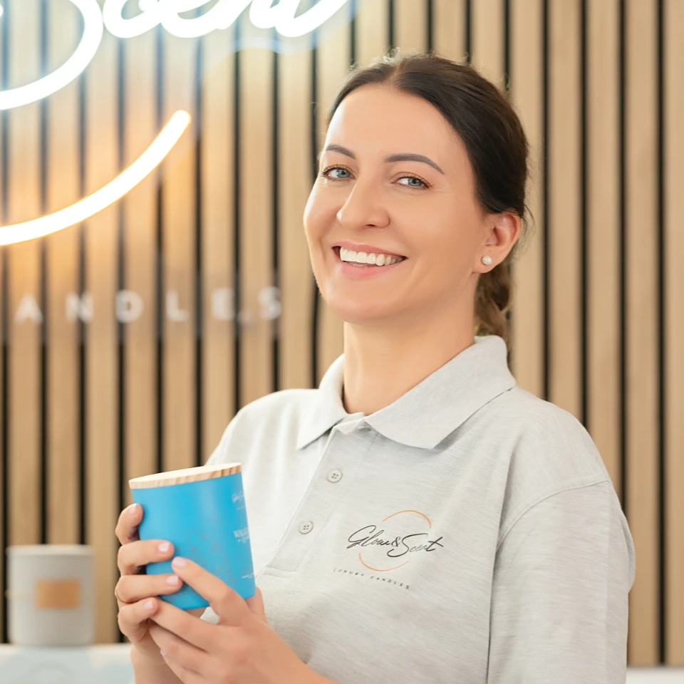 The Story Behind the Glow Karolina holding a candle and smiling